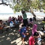 Kegiatan Komunitas Sekolah SDN Sowa, Kecamatan Soromandi, Kabupaten Bima, saat belajar di pantai. Suasana alam dimanfaatkan sebagai ruang belajar alternatif untuk menciptakan pembelajaran yang menyenangkan dan meningkatkan semangat belajar siswa.